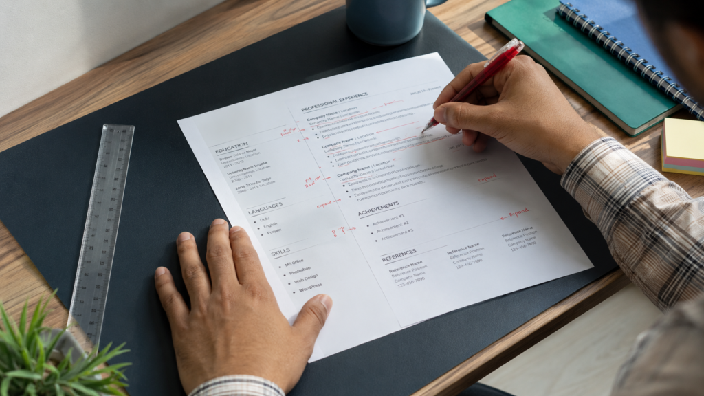 Cluttered resume layout being corrected showing common resume mistakes to avoid